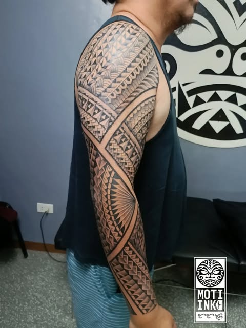Polynesian tribal full sleeve with radial sunburst on the forearm