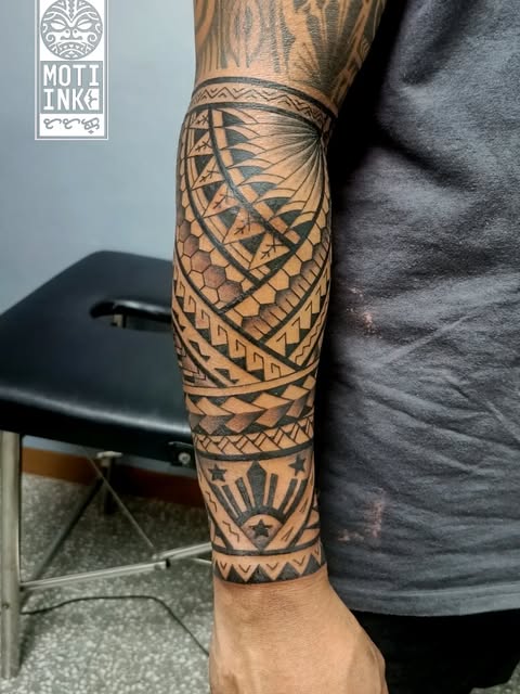 Filipino tribal forearm with the three-star-and-sun Philippine motif